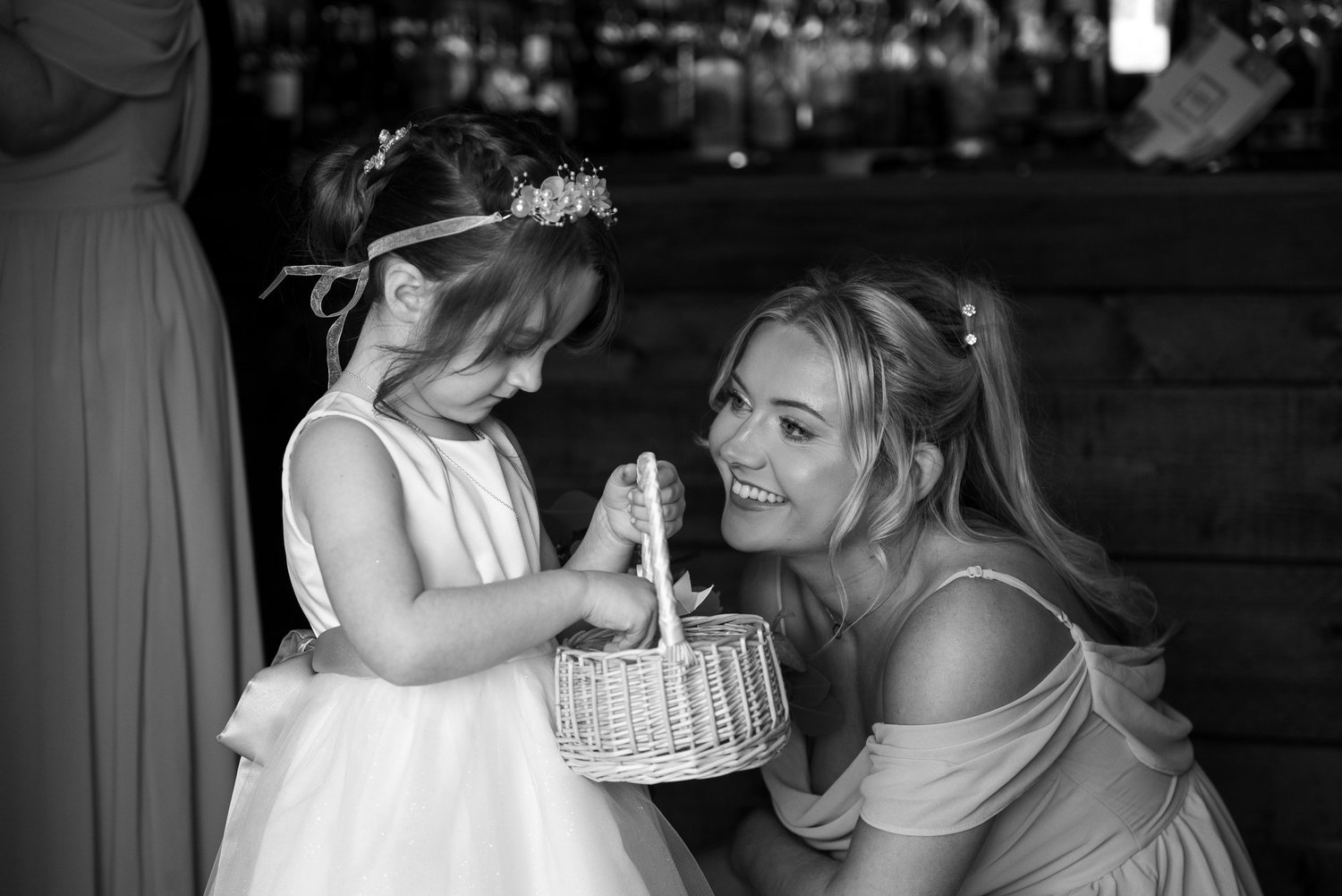A quiet moment between a bride and a little girl
